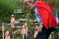 Jean placing her rose