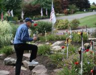 Bill placing a rose
