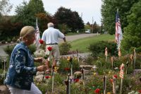 Joanne placing a rose