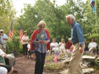 Jean placing her rose