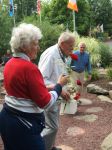Mary Ann placing her rose